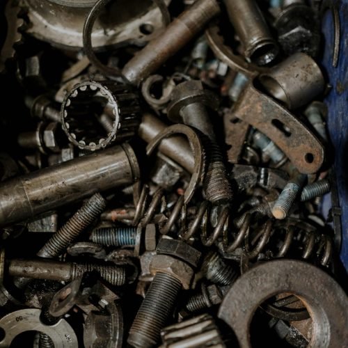 A detailed close-up of various metal gears and spare parts, perfect for industrial themes.